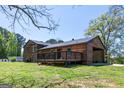 Exterior view of a house showing the wooden deck and partially bricked section of the house at 1919 101 S Hwy, Temple, GA 30179