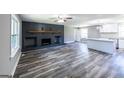 Open-concept living room with gray walls, wood floors, and a modern kitchen with white cabinets at 1919 101 S Hwy, Temple, GA 30179