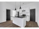 Modern kitchen featuring white cabinets, black hardware, subway tile backsplash and black granite island at 1226 Byewood Sw Ln, Atlanta, GA 30310