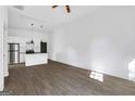 Bright living room with wood-look flooring and kitchen in the background at 1226 Byewood Sw Ln, Atlanta, GA 30310