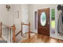 Inviting foyer with wood floors, staircase, and a glass-accented front door providing lots of natural light at 507 N Green Cir, Mcdonough, GA 30252