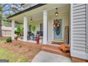 Inviting front porch featuring rocking chairs, a wreath, and potted plants at 140 Laurel Lake Rd, Tyrone, GA 30290