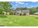 Inviting two-story home with mature trees and a well manicured front yard at 140 Laurel Lake Rd, Tyrone, GA 30290