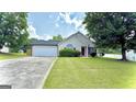 Lovely one-story home with a welcoming front yard, attached garage, and classic suburban charm at 6638 Creek Turn Dr, Rex, GA 30273