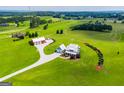 Overhead view of the modern farmhouse and barn nestled within a sprawling green landscape at 385 Liberty Church Rd, Carrollton, GA 30116