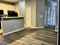 Open living space with sleek floors and neutral walls, next to the kitchen with white cabinets at 5057 Windsor Forrest Lane, Atlanta, GA 30349
