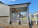 Brick back porch with white railings, perfect for entertaining or relaxing at 35 Fraser Ln # 123B, Auburn, GA 30011