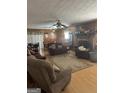 Spacious living room with hardwood floors, brick fireplace and vintage ceiling fans at 2534 Highway 155 N, Mcdonough, GA 30252