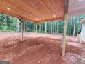 Spacious open carport featuring a wooden ceiling and sturdy support beams at 55 Etheridge Rd, Temple, GA 30179