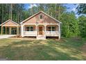 Inviting home with a covered front porch, detailed trim and shutter, and a well-manicured lawn at 55 Etheridge Rd, Temple, GA 30179