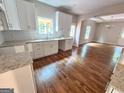 Bright kitchen featuring white cabinets, granite countertops, and stainless steel sink at 55 Etheridge Rd, Temple, GA 30179