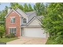 Charming two-story home featuring brick accents, a two-car garage, and a white front door at 2576 Abbotts Glen Nw Dr, Acworth, GA 30101