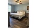 Serene bedroom with a neutral palette, a comfortable king-size bed, and wood-look flooring at 517 Pebble Pt, Loganville, GA 30052