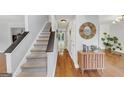 Inviting foyer features a staircase, hardwood floors, and modern decor, creating a warm welcome at 1625 Clark Lake Nw, Acworth, GA 30102