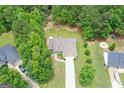 Aerial view of home on a spacious lot, surrounded by lush greenery and mature trees at 320 Cobb Ct, Hampton, GA 30228