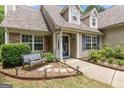 Inviting front entrance with a bench, stepping stones, and landscaping leading to the front door at 320 Cobb Ct, Hampton, GA 30228