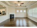 Open living area features a fireplace, tray ceilings, and hardwood floors at 2047 Gazebo Ln, Snellville, GA 30078
