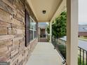 Stone porch features stone wall accents and a black metal railing at 2047 Gazebo Ln, Snellville, GA 30078