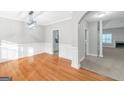 Bright dining room featuring hardwood floors, wainscoting, and an elegant light fixture at 185 Stewart Glen Dr, Covington, GA 30014