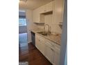 Well-equipped kitchen with granite countertops, white cabinets, and stainless steel appliances at 5579 Marbut Rd, Lithonia, GA 30058
