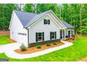 Well-maintained single-story home with a side garage, complemented by a lush green lawn and manicured landscaping at 5525 Belle Meade Dr, Villa Rica, GA 30180