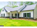 Charming single-story house featuring black shutters, a lush green lawn, and manicured landscaping in a tranquil setting at 5525 Belle Meade Dr, Villa Rica, GA 30180