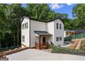 Beautiful two-story home with white siding, a metal roof, a welcoming front porch, and mature trees at 2328 Lakewood Ave Sw, Atlanta, GA 30315