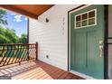 Inviting front porch with wooden railings, a green front door with glass, and the house number at 2328 Lakewood Ave Sw, Atlanta, GA 30315
