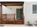 Charming front porch with wooden railings, a green front door, and white trim at 2328 Lakewood Ave Sw, Atlanta, GA 30315