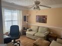 Cozy living room featuring a comfortable sofa, natural light from a window, and a ceiling fan at 740 Pebble Blvd, Covington, GA 30016