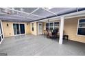 Spacious screened-in porch with neutral tones and outdoor seating area at 155 Cottage Club Dr, Locust Grove, GA 30248