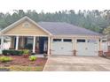 Charming home with a two-car garage, inviting porch, and well-kept landscaping at 155 Cottage Club Dr, Locust Grove, GA 30248