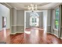 Elegant dining room with chandelier and large window at 185 Newfield Dr, Tyrone, GA 30290