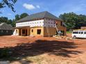 Exterior view of new home construction, featuring black roof and framed windows at 140 Wilson Drive, Mcdonough, GA 30252