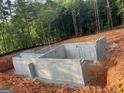 New home foundation showcases a basement on a wooded lot at 150 Wilson Dr, Mcdonough, GA 30252