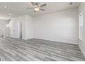Spacious living room with modern ceiling fan, neutral walls, and stylish gray floors at 493 Prescott Way, Villa Rica, GA 30180