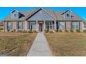 Beautiful home with brick and siding, dormer windows, and well-maintained lawn at 1141 Abundance Dr, Locust Grove, GA 30248