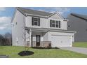 Two-story home showcasing light siding, black shutters, covered porch, and attached two-car garage at 481 Prescott Way, Villa Rica, GA 30180