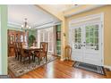 Formal dining room with hardwood floors, classic chandelier, china cabinet and french doors at 120 Oak Shadow Way, Fayetteville, GA 30215