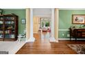Open foyer showcasing hardwood flooring, decorative columns, and a glimpse into the living room at 120 Oak Shadow Way, Fayetteville, GA 30215