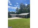 Lovely single-story home with attached garage and lush green lawn at 3705 Sandhill Se Dr, Conyers, GA 30094