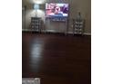 Comfortable living room with hardwood floors, TV, and side tables at 85 Bermuda Run Dr, Covington, GA 30016