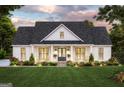 Inviting facade of a home featuring a manicured lawn, rocking chairs, and dark roof at 380 Ayers Rd, Bowdon, GA 30108