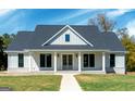 Charming single-story home boasting a manicured lawn, gray roof, and inviting facade at 380 Ayers Rd, Bowdon, GA 30108