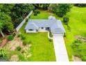 Aerial view of ranch-style home with well-maintained lawn, privacy fence, and long driveway at 65 Pine Haven Ct, Carrollton, GA 30116