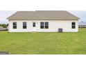 Spacious backyard with healthy lawn, rear home entry, and external AC unit at 280 Oliver Dr, Locust Grove, GA 30248