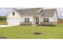 Charming single Gathering home showcasing a well-maintained lawn and welcoming entrance at 280 Oliver Dr, Locust Grove, GA 30248