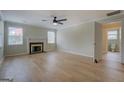 Spacious living room with a fireplace, light-colored hardwood floors, and plenty of natural light at 4131 Carroll Sw St, Covington, GA 30014