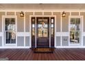 Inviting front entrance with beautiful hardwood door, sidelights, and stylish lanterns at 3170 Monroe Jersey Rd, Covington, GA 30014