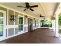 Spacious covered front porch with comfortable seating, ceiling fans, and great curb appeal at 3170 Monroe Jersey Rd, Covington, GA 30014